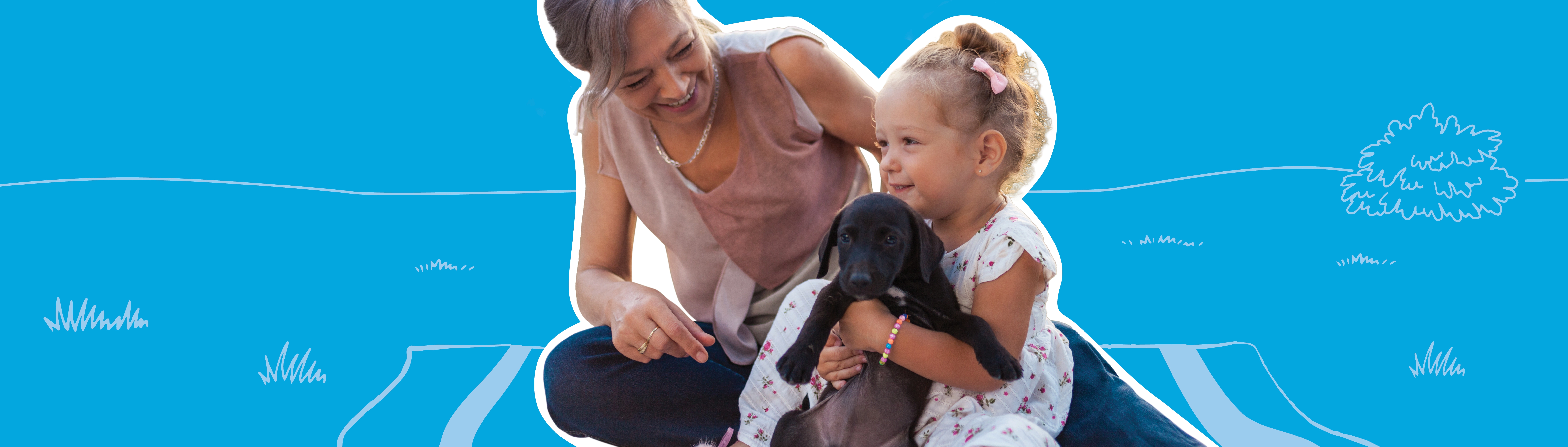 woman with a girl holding a puppy